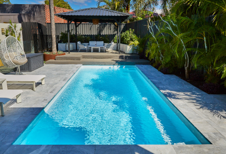 jurien pool surrounded by grey paving and green trees